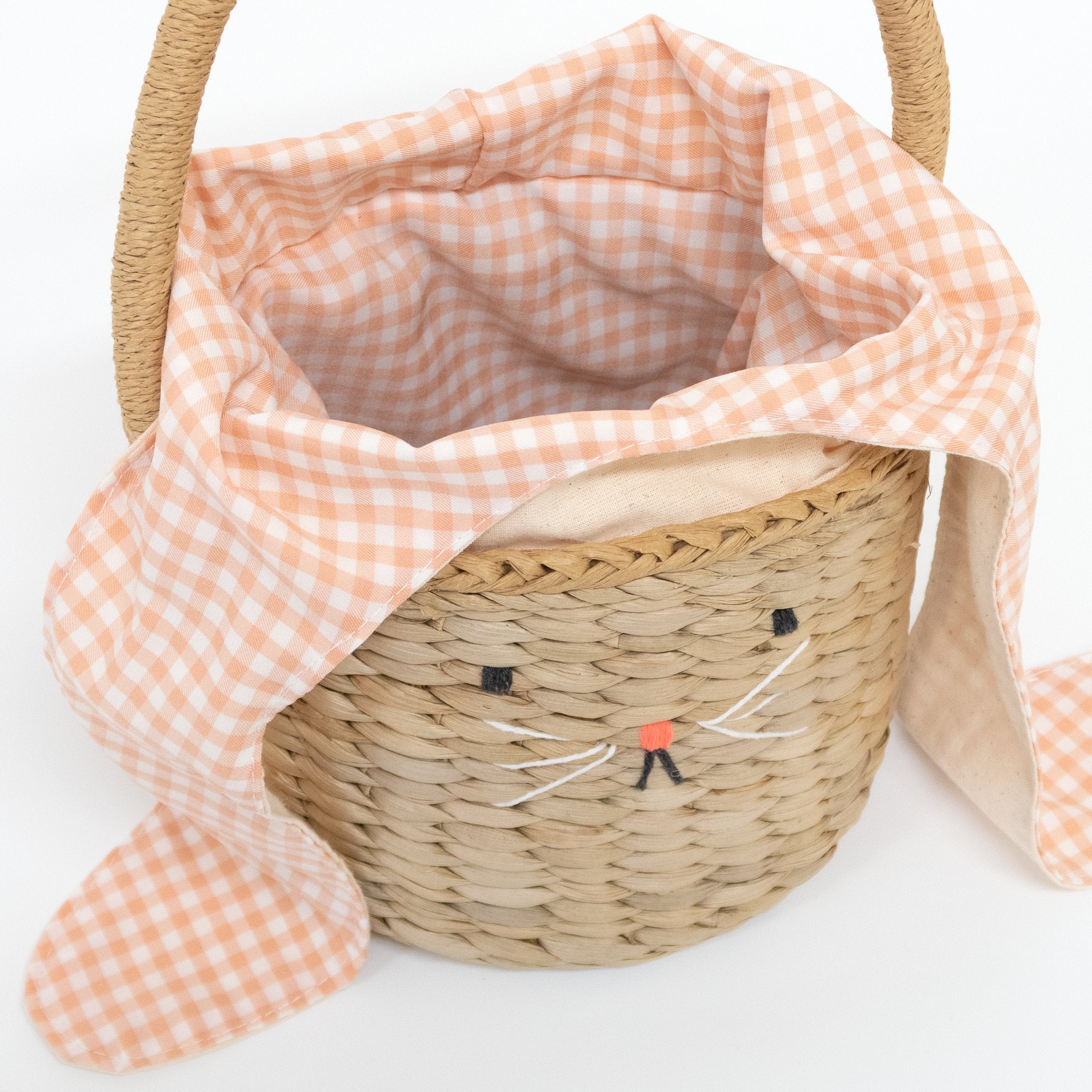 This basket is crafted from woven straw, with floppy ears, a sweet bunny face and a dellightful pompom tail.