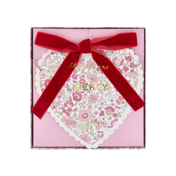 Our Valentine's Day garland feature paper hearts with floral Liberty print designs and pink and red luxe velvet bows. Image6