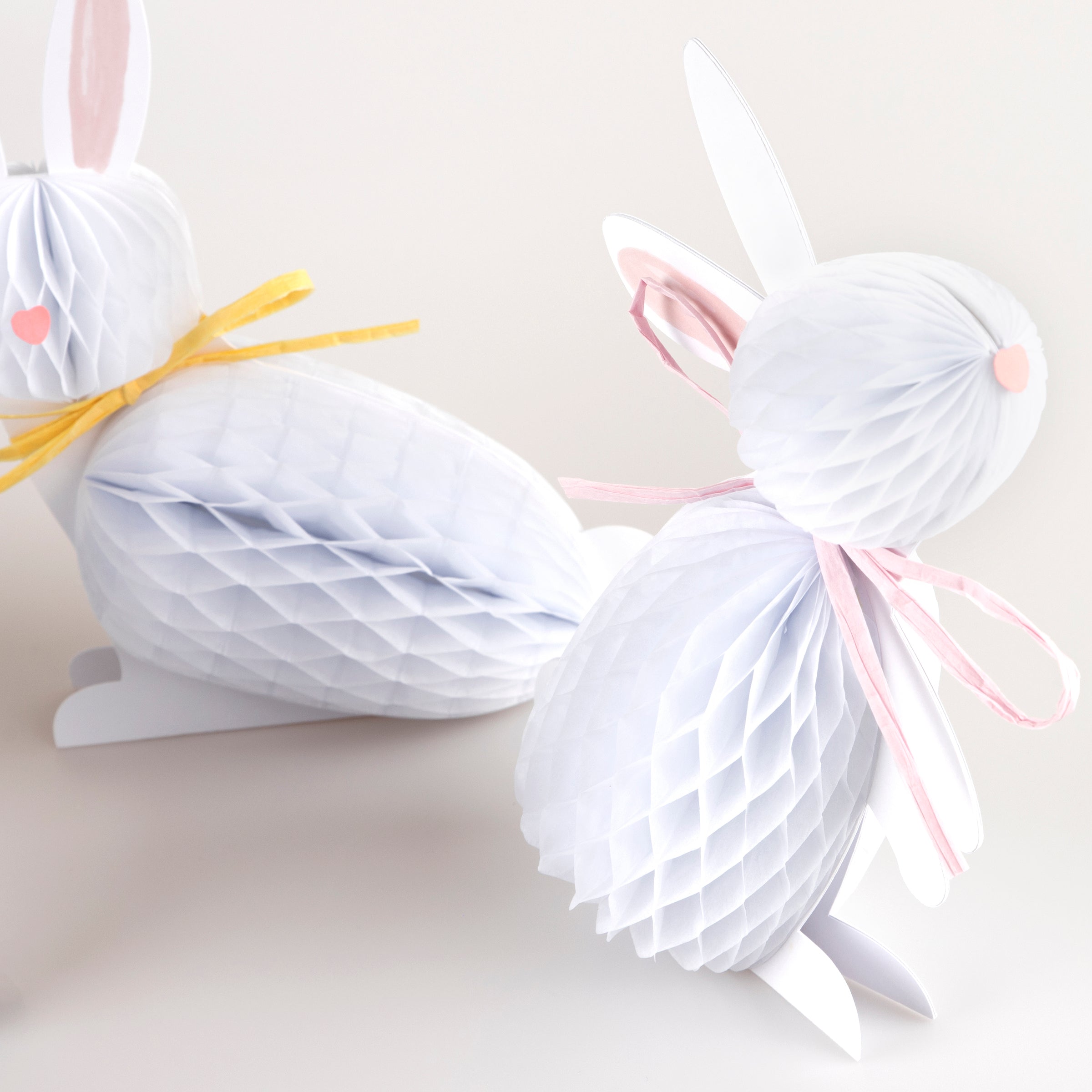 Our Easter bunny decorations, crafted with honeycomb paper and raffia ribbons, look amazing.