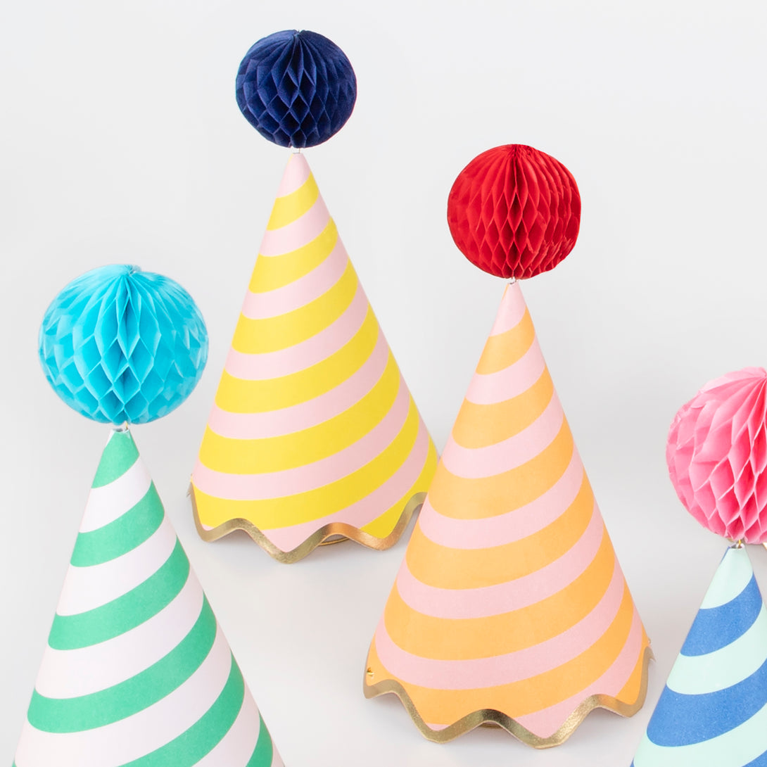 Our party accessories include hats with stripes and pompoms for a fun look.