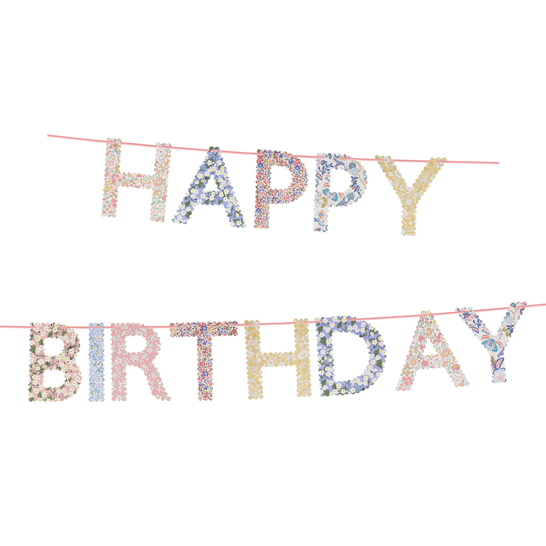 Our happy birthday garland features scalloped pennants with Liberty print designs, pre-strung on a pink velvet ribbon.