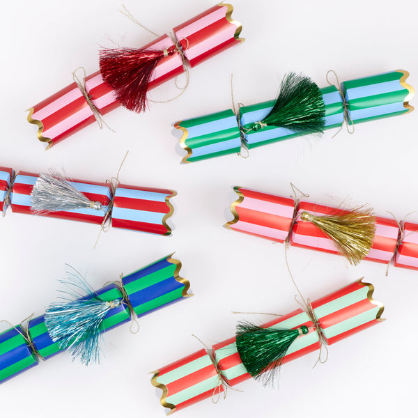 Our Christmas no-snap party crackers, with fun stripes and tinsel tassel details, contain a gold party hat, joke and a small gift. Image5