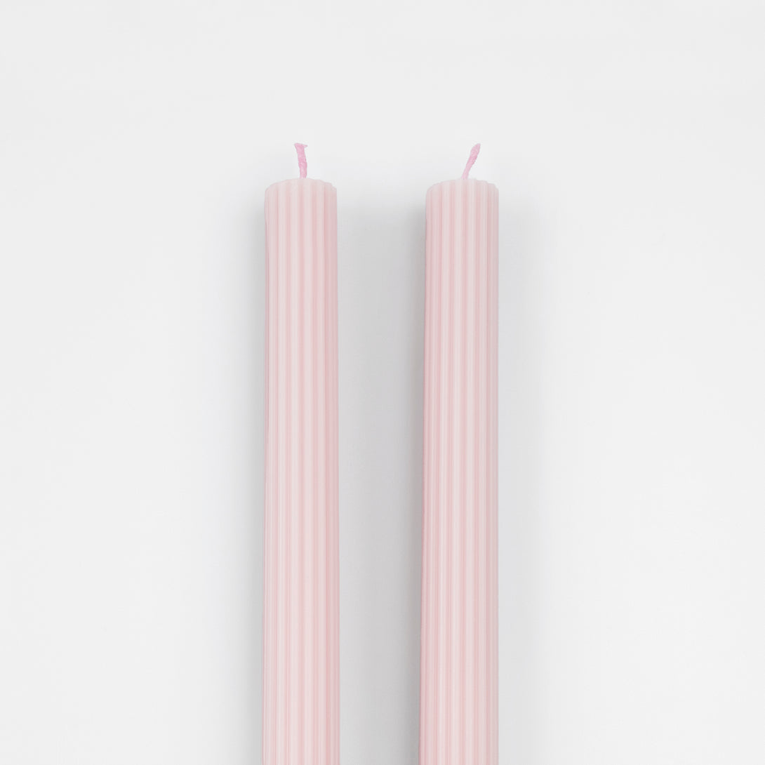 Our tall candles, in a pink colour with ridged details, add a stunning look to any party.