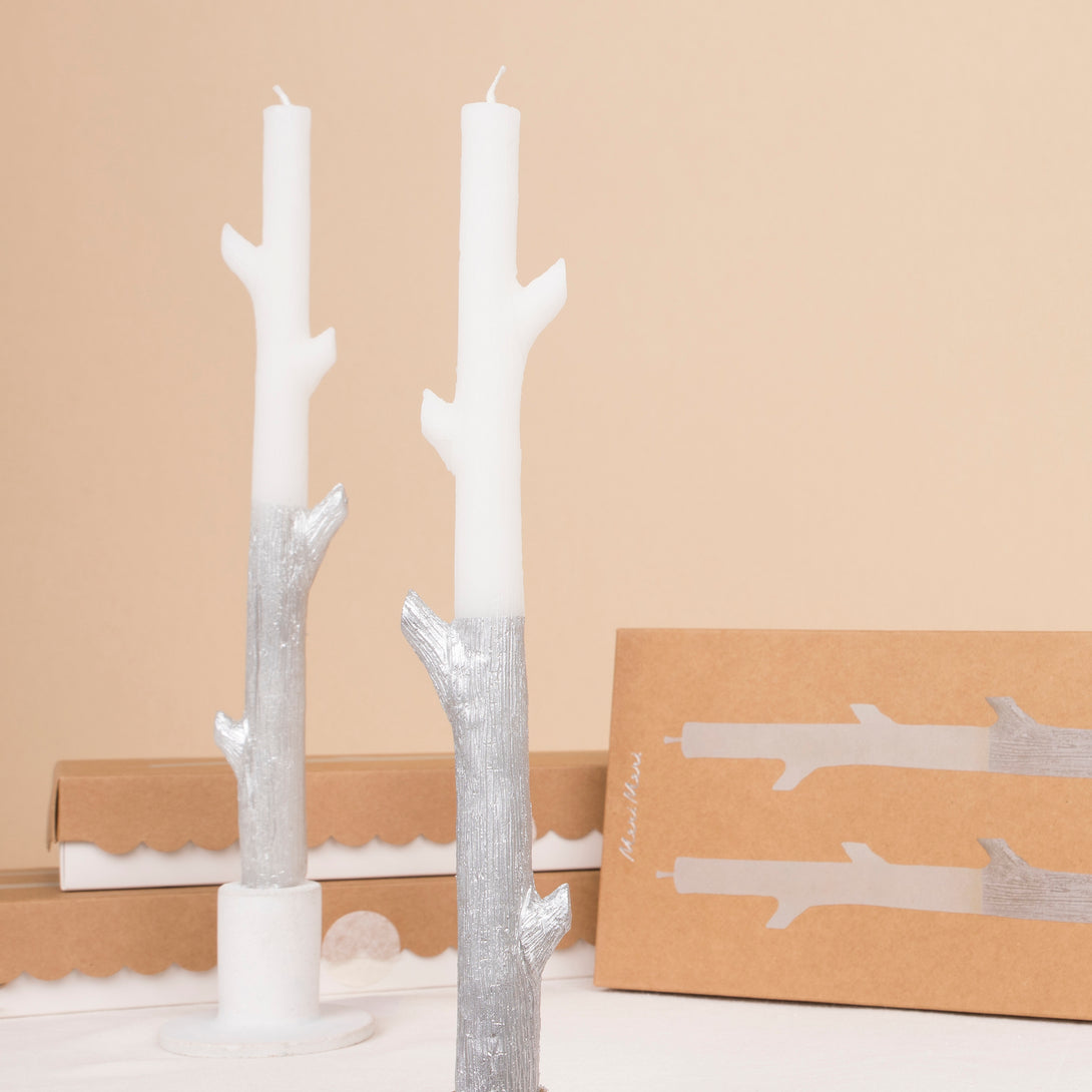 Our tall candles, shaped like sticks and dipped in silver ink, will look amazing as Halloween or Christmas table decorations.