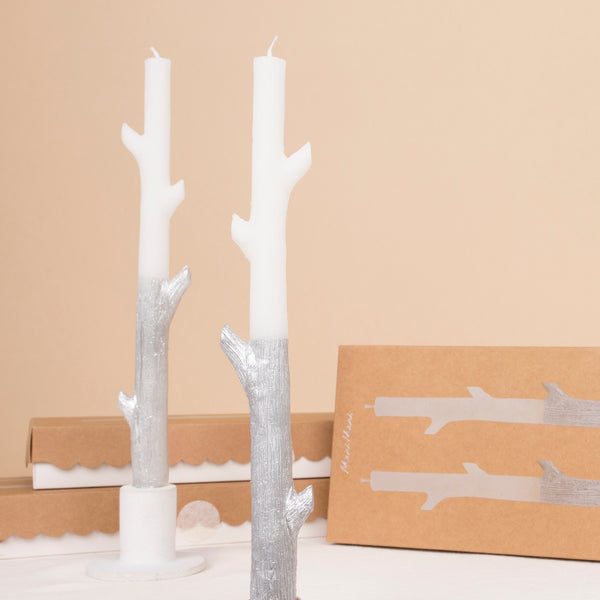 Our tall candles, shaped like sticks and dipped in silver ink, will look amazing as Halloween or Christmas table decorations.