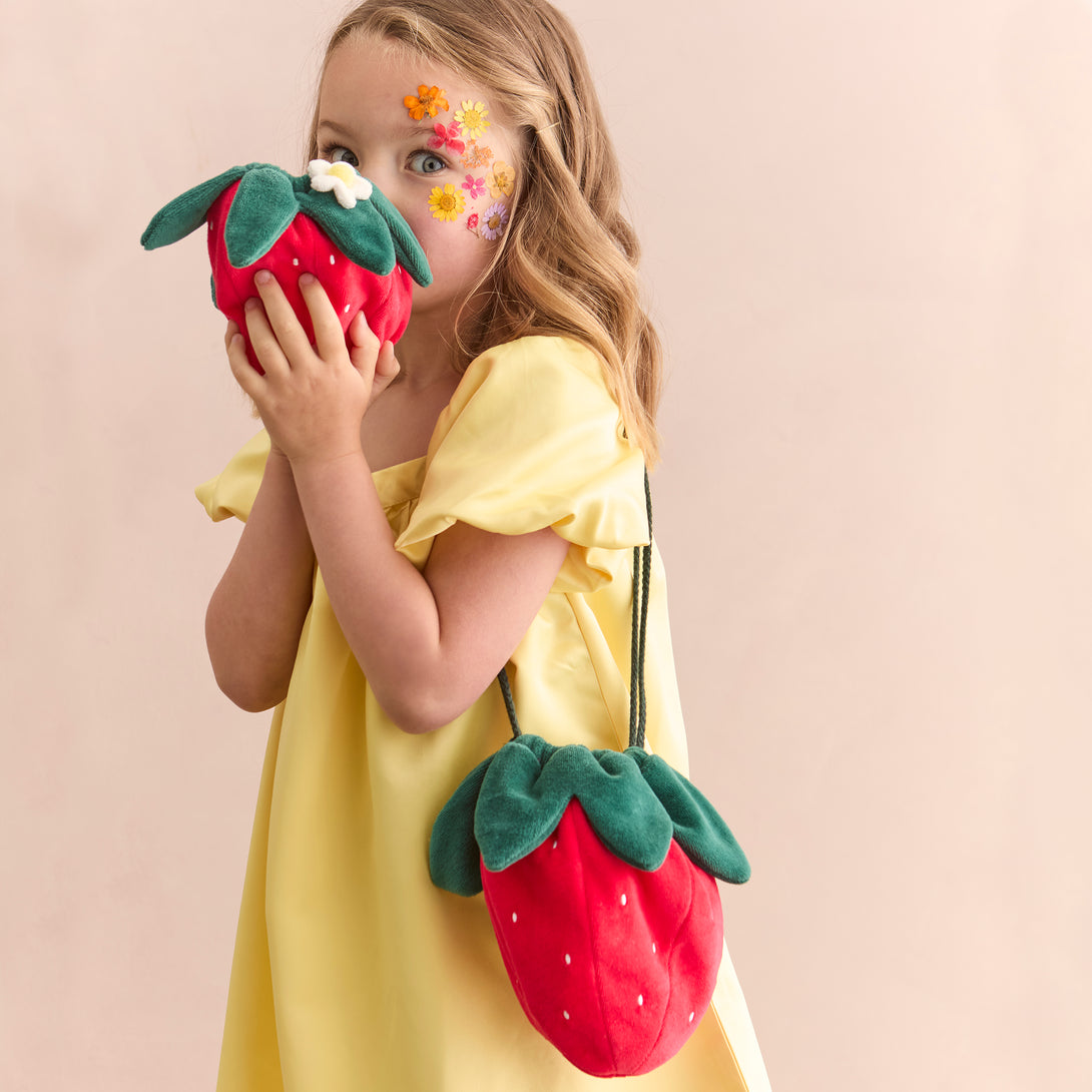 Our accessories for kids range includes a stunning strawberry bag crafted from soft velvet.