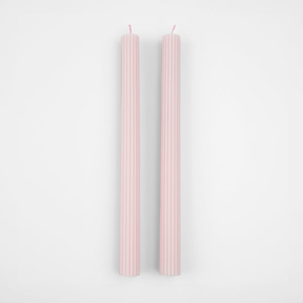 Our tall candles, in a pink colour with ridged details, add a stunning look to any party.