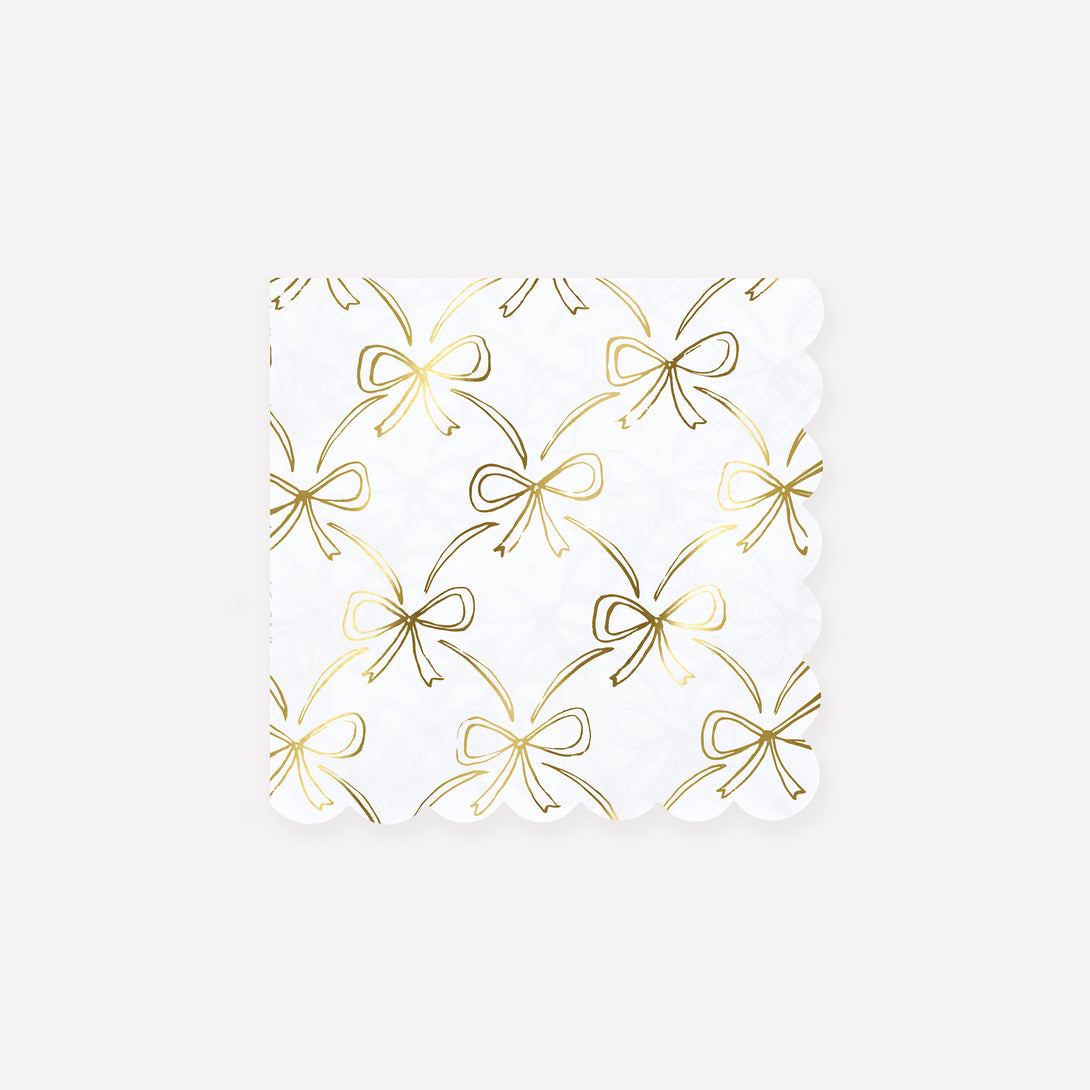Our golden Christmas host gift set includes two table candles, with gold stripy bow details, and a pack of paper napkins with gold bow designs. 