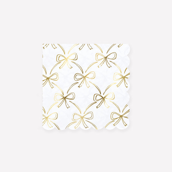 Our golden Christmas host gift set includes two table candles, with gold stripy bow details, and a pack of paper napkins with gold bow designs. 