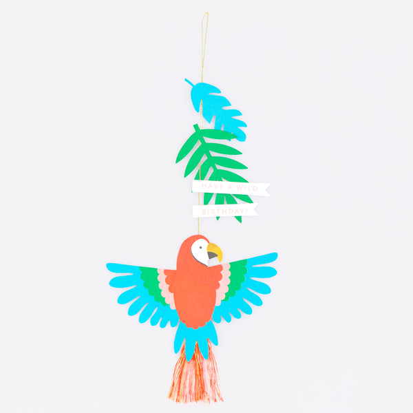 Our birthday card features a vibrant parrot with a tassel tail, with gold cord for hanging it to create a wonderful birthday decoration. Image1