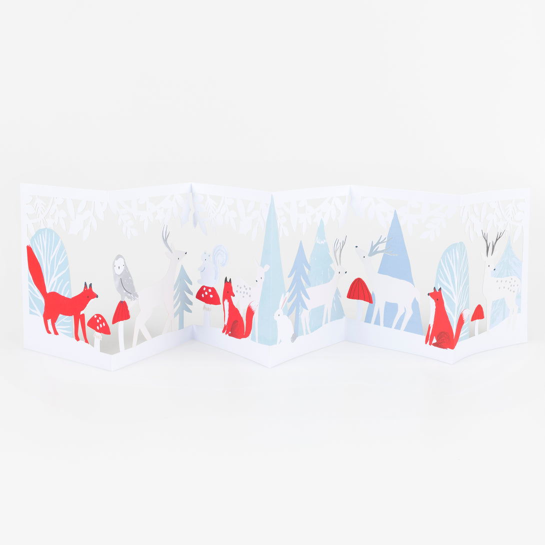 Our concertina card for Christmas opens up to show a winter woodland scene with animals, funghi and foliage, a beautiful decoration. Image2
