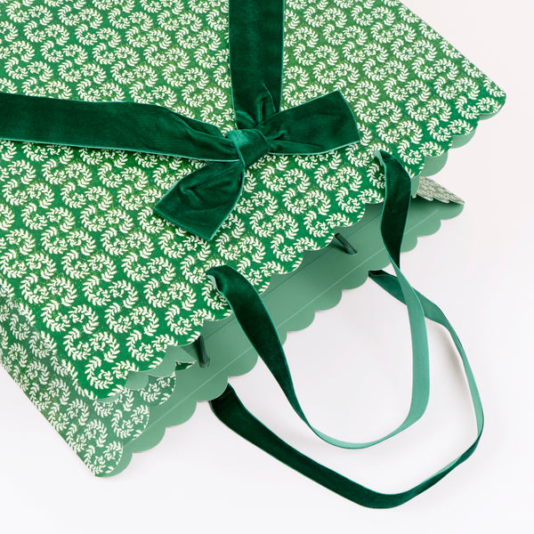 Our large Christmas gift bags, made from premium paper, feature Molly Mahon block print designs with velvet bows and velvet handles. Image2