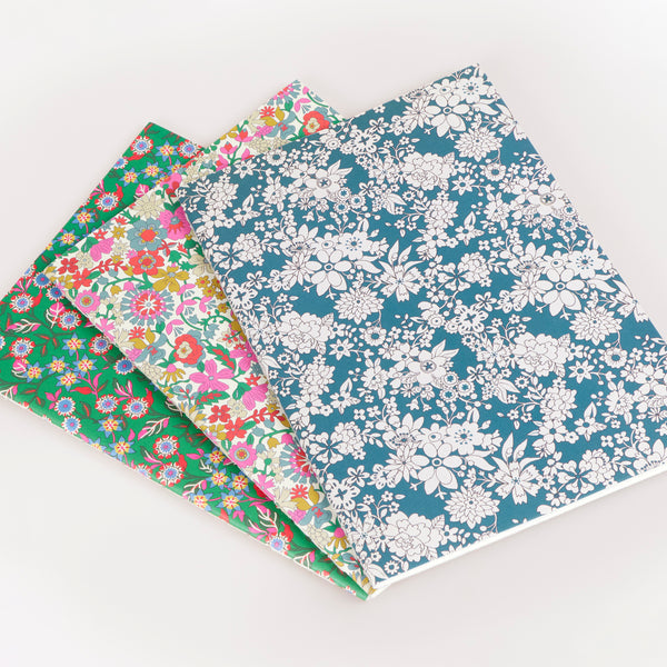 Our soft Christmas notebook set of three have pretty floral Liberty print design covers in tones of green, and lined pages, ideal for gifting. Image2