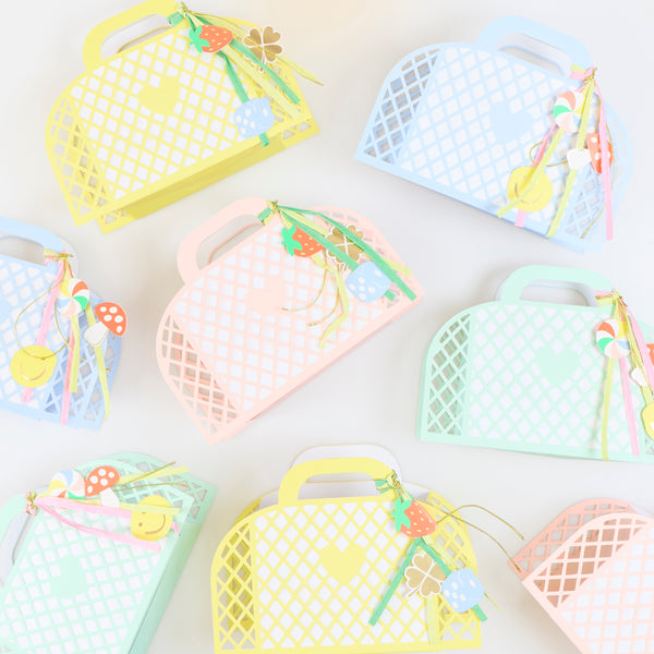 Our party favour bags are designed to look like little baskets, in pink, blue, mint and yellow, complete with paper charms tied on with ribbons. Image4