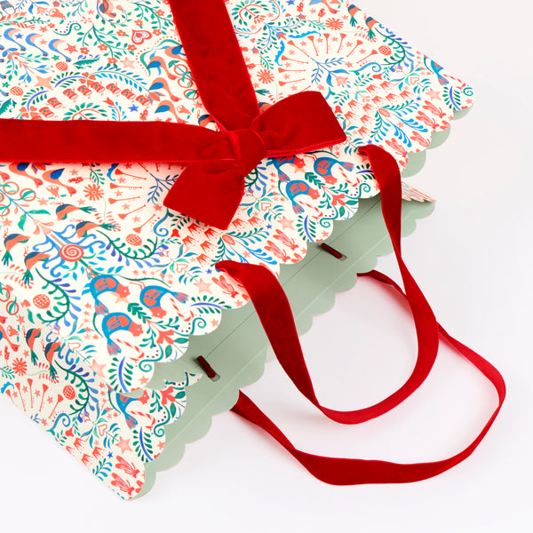 Our large paper Christmas gift bags feature Liberty print designs for an elegant look, with three designs, velvet ribbon bows and handles. Image2