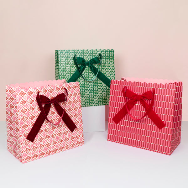 Our large Christmas gift bags, made from premium paper, feature Molly Mahon block print designs with velvet bows and velvet handles. Image1