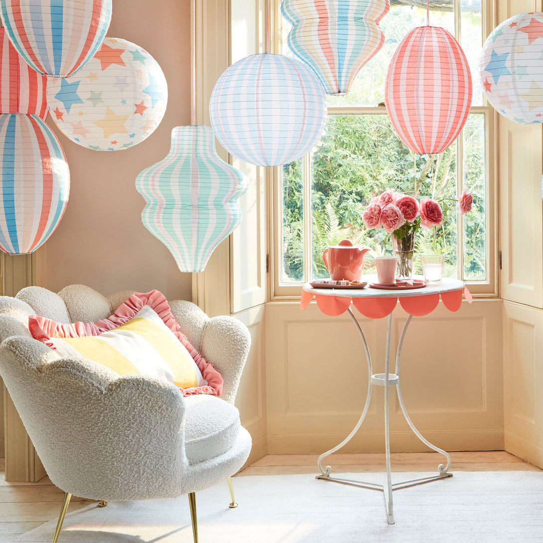 Decorate a room with our striped lanterns, crafted from paper with a pink cord for hanging.