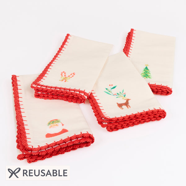 Our Christmas fabric napkins are made from an ivory linen and cotton blend, with festive motifs, embroidered details and crochet borders. Image1