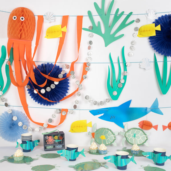 Make your under the sea birthday party look amazing with our sea creature garland, turtle plates, napkins, shark cups and a cupcake kit. 