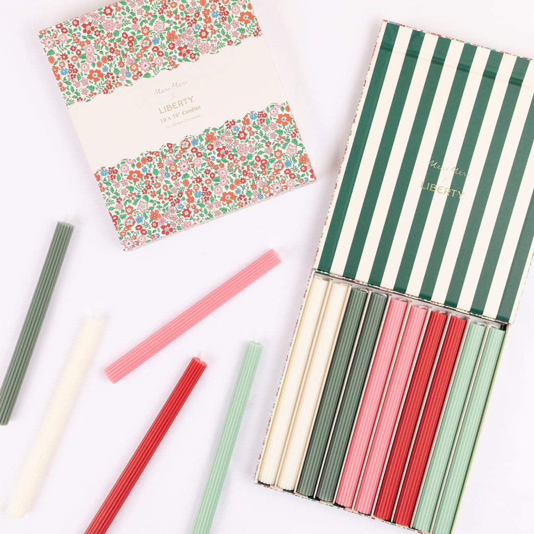 Our Christmas candle gift box features 10 ridged table candles, in 5 joyful colours, presented in a box with a classic Liberty print designs. Image1