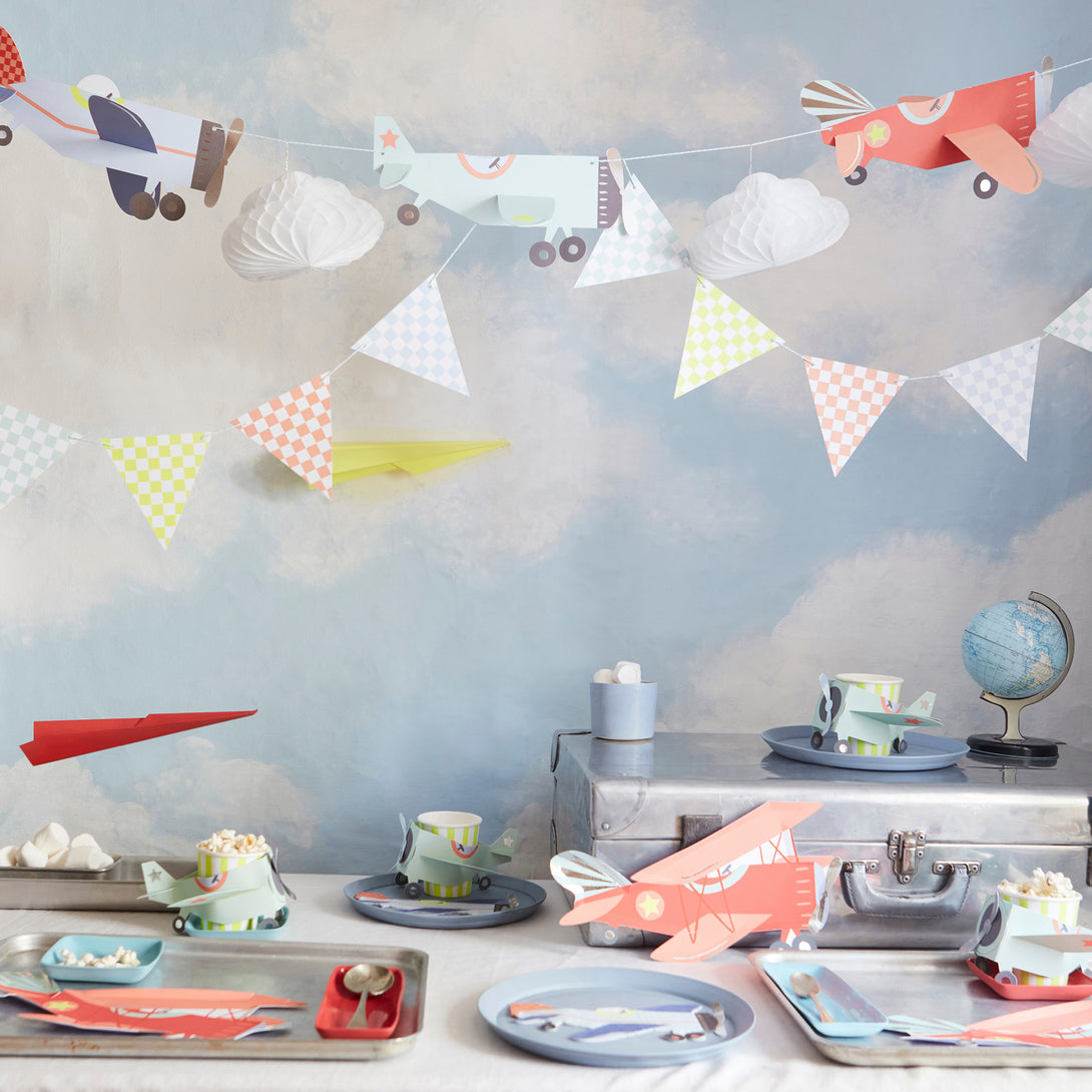 Kids who love airplanes will love our airplane party set which includes an airplane garland, plates, napkins and cups. 