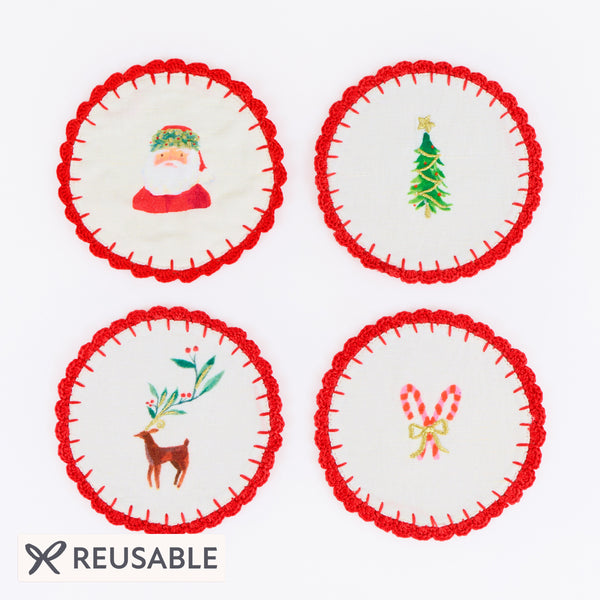 Our fabric cocktail napkins for Christmas are made with a linen and cotton blend, festive motifs, red crochet borders and gold embroidery. Image1