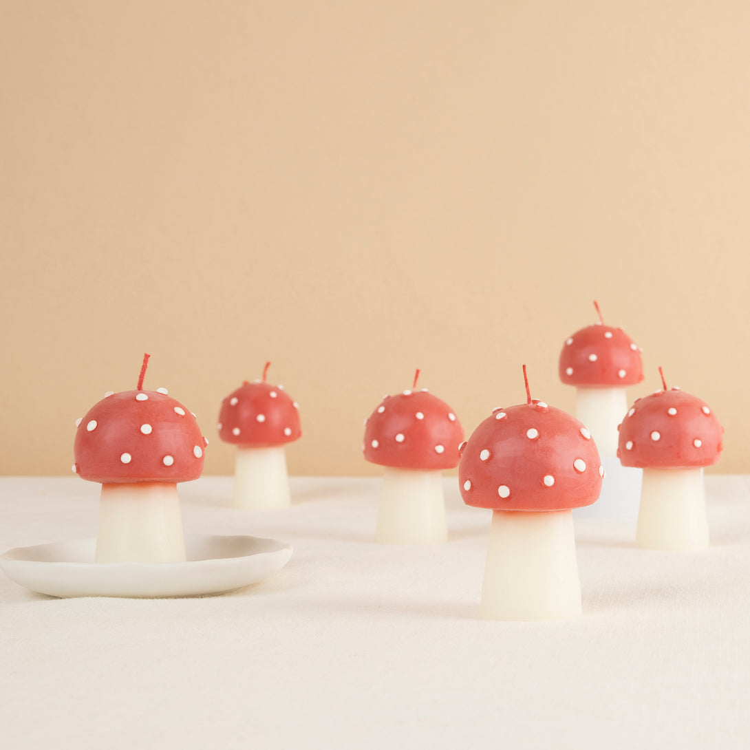 Our Christmas candles, are shaped like little mushrooms, in red and white with red wicks.