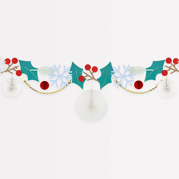 Our Christmas garland includes Christmas foliage with paper holly, berries, snowflakes and honeycomb decorations.