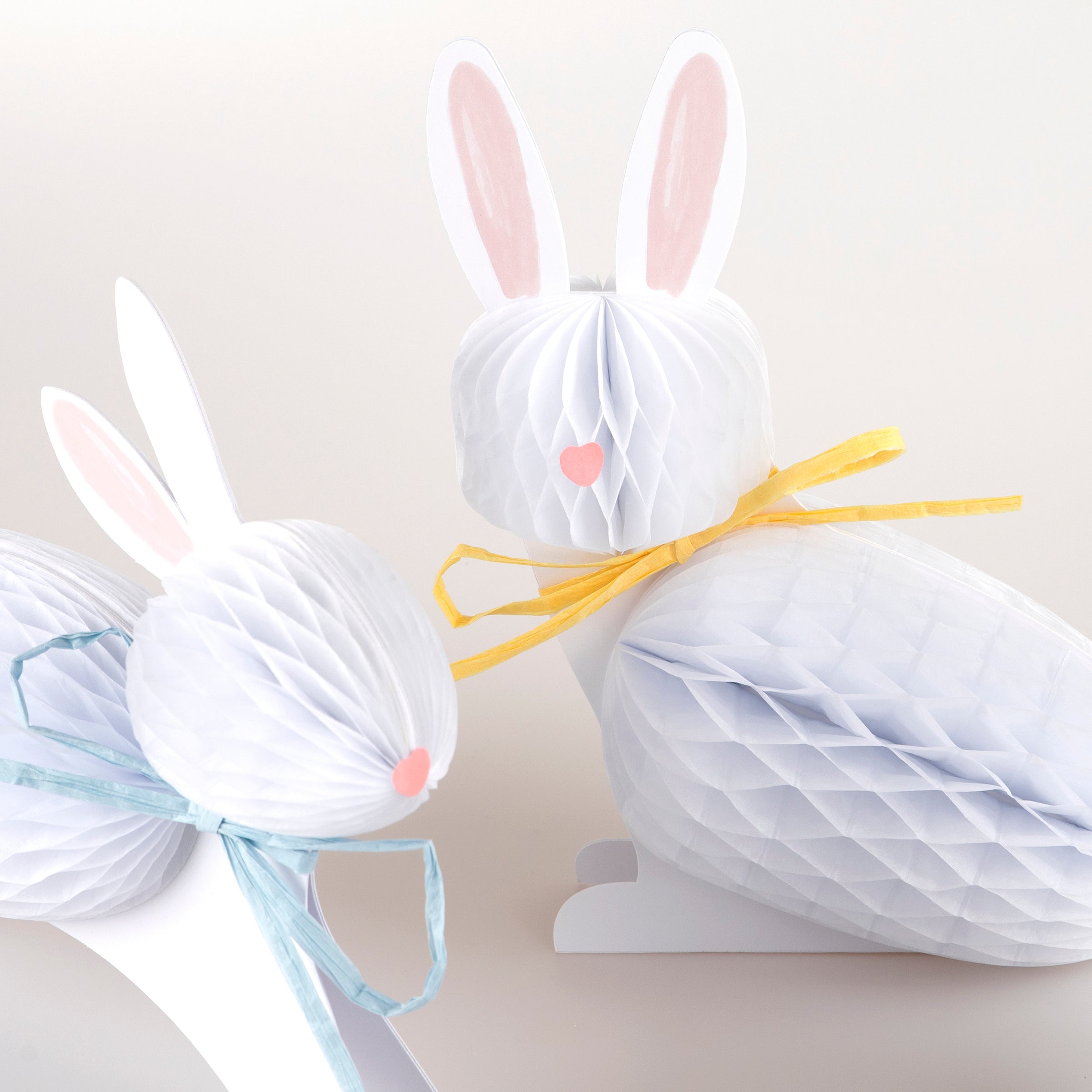 Our Easter bunny decorations, crafted with honeycomb paper and raffia ribbons, look amazing.