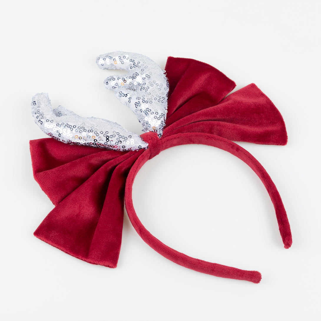 Our reindeer headband is a fabulous accessory to wear to Christmas parties, with silver sequin antlers, and a red velvet bow and headband. Image2