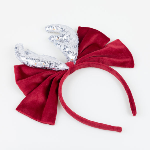 Our reindeer headband is a fabulous accessory to wear to Christmas parties, with silver sequin antlers, and a red velvet bow and headband. Image2