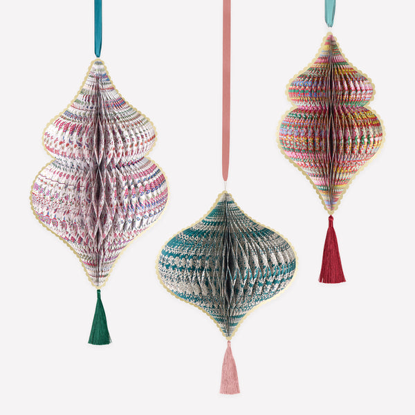 Our large Christmas decorations feature 3D honeycomb details, Liberty print designs in rich seasonal colours, tassels and satin ribbons. Image1