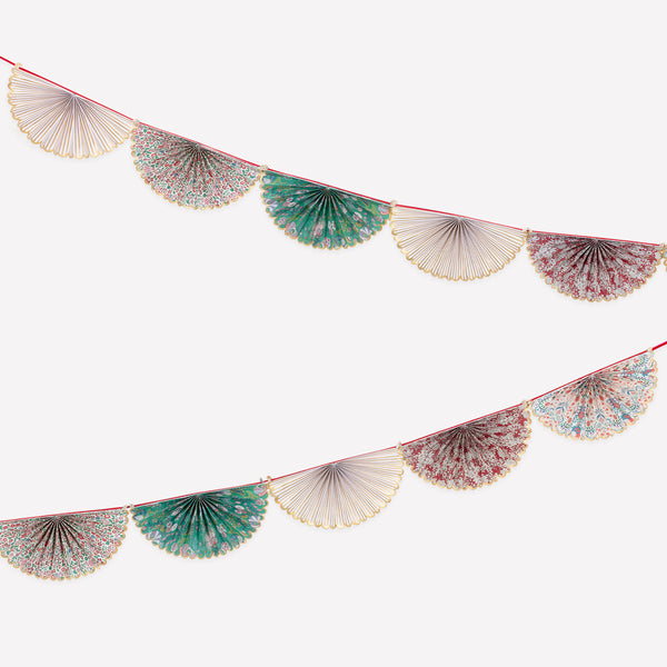 Our elegant Christmas garland has Liberty prints and matt gold foil details, pre-threaded on to a stylish red velvet ribbon. Image1