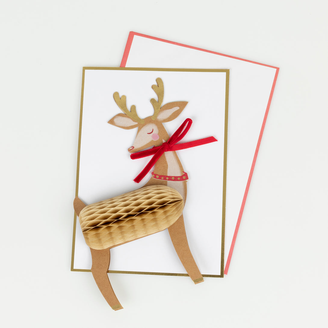 Our reindeer Christmas card stands up to give a wonderful decoration, and features honeycomb paper, a luxe velvet bow and shiny gold foil. Image2