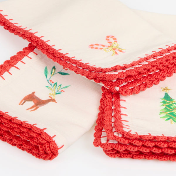 Our Christmas fabric napkins are made from an ivory linen and cotton blend, with festive motifs, embroidered details and crochet borders. Image3