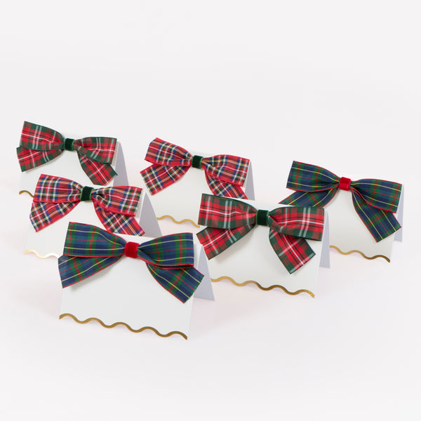 Our Christmas place cards feature scalloped edges with shiny gold foil details and are beautifully topped with tartan and velvet ribbon bows. Image1