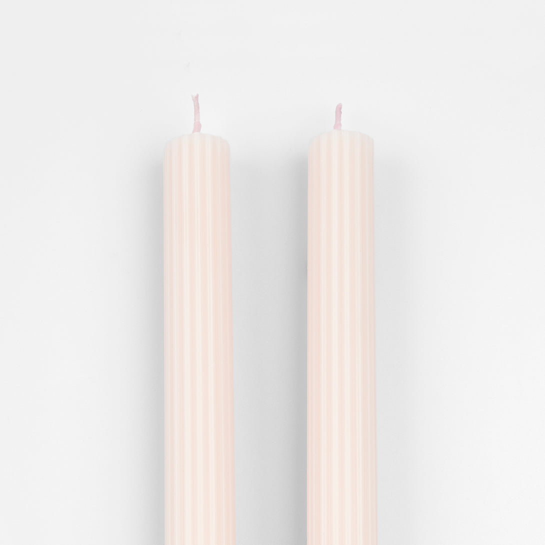 Decorate your table or mantel with our ridged long candles in a pretty peach pink shade.