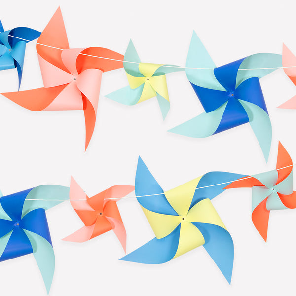 Our paper pinwheel garland is the perfect statement party decoration for a pool party, beach birthday or where you want a summer party vibe. Image1