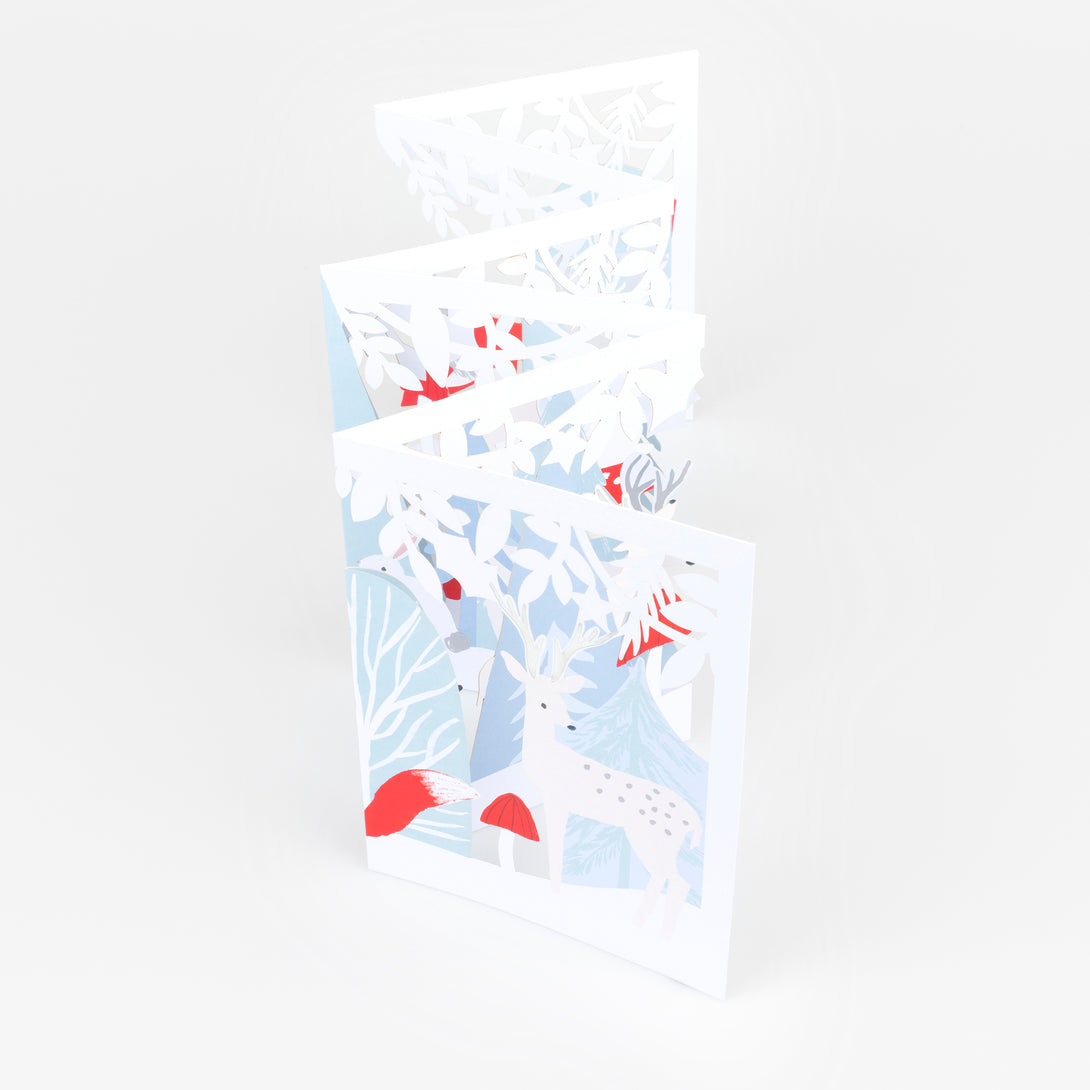 Our concertina card for Christmas opens up to show a winter woodland scene with animals, funghi and foliage, a beautiful decoration. Image1