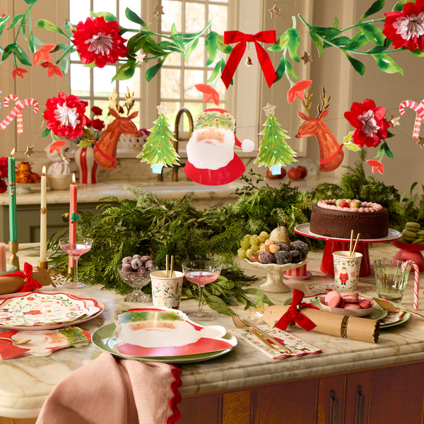 Our decorative set includes a Christmas garland with festive characters and another with foliage pennants, a velvet bow and a tinkling bell. Image2