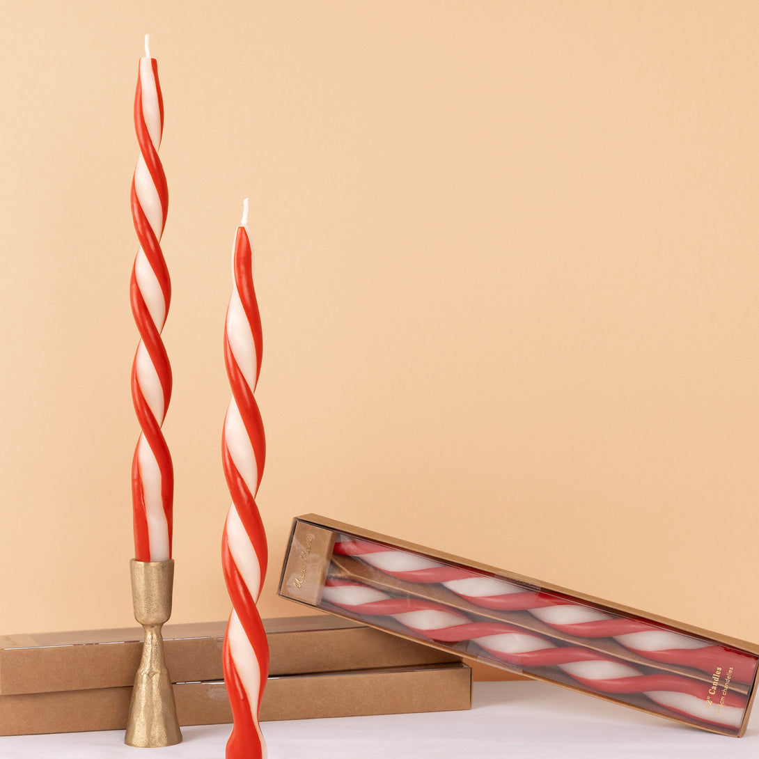Add a colourful look to your Christmas table with our ivory candles with a stunning twist of red. Image1