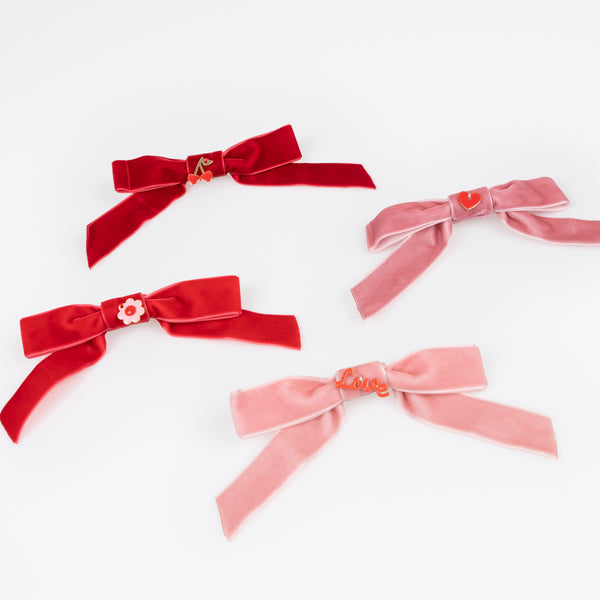 Our Valentine's hair accessories, made with soft velvet bows and enamel charms, make great Valentine's day gifts. Image2