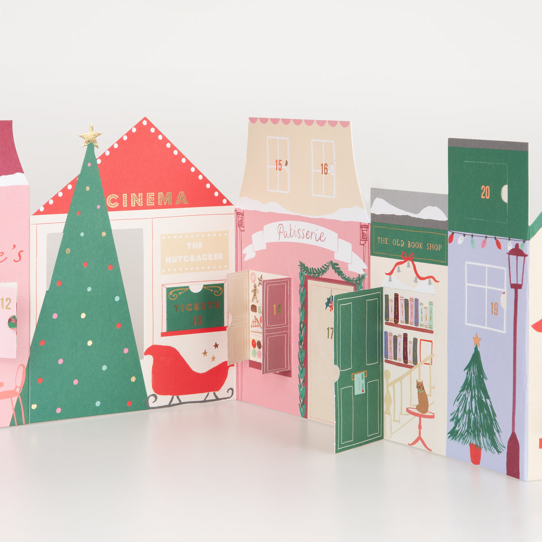 Our paper advent calendar is designed to look like Christmas street scene, with festive illustrations behind the windows and doors.