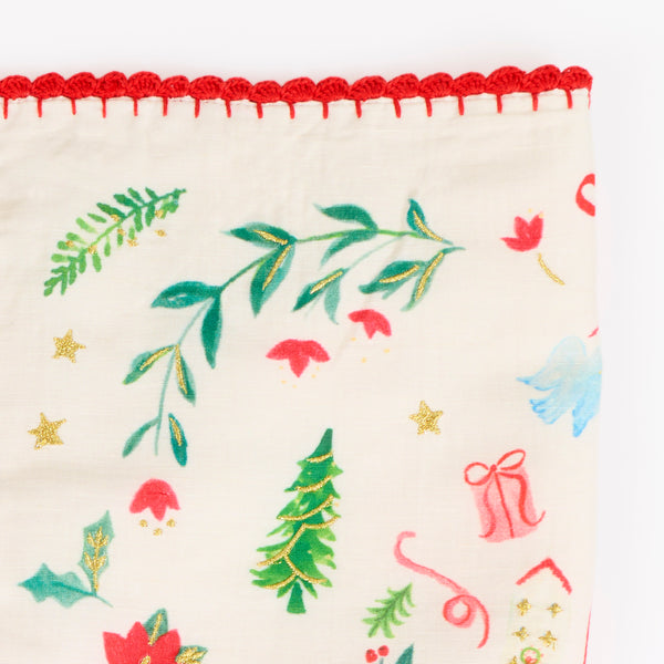 Our Christmas placemats, made from a linen and cotton mix, feature Santa in a folk-inspired scene, with gold embroidery and a crochet trim. Image5