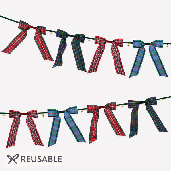 Our statement Christmas garland features large tartan bows with tinkling bells, perfect for hanging wherever you want seasonal sophistication. Image1
