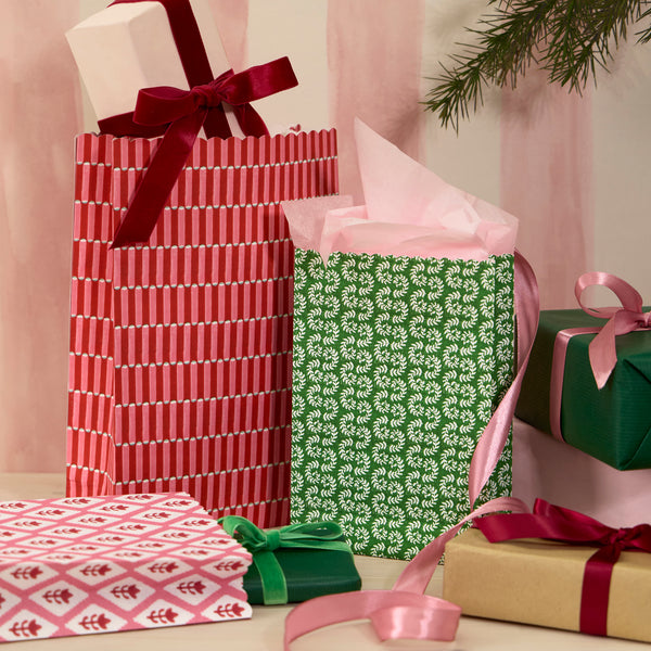 Our Christmas gift bags, made from premium paper, feature a set of 10 with Molly Mahon block print designs in shades of red, pink and white. Image2
