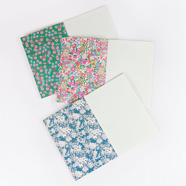 Our soft Christmas notebook set of three have pretty floral Liberty print design covers in tones of green, and lined pages, ideal for gifting. Image3