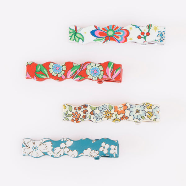 Our Christmas hair clips feature 8 different Liberty floral print designs and an elegant wavy shape, perfect to elevate your festive hair styles. Image4