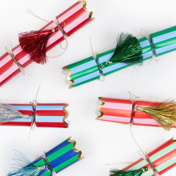 Our Christmas no-snap party crackers, with fun stripes and tinsel tassel details, contain a gold party hat, joke and a small gift. Image4