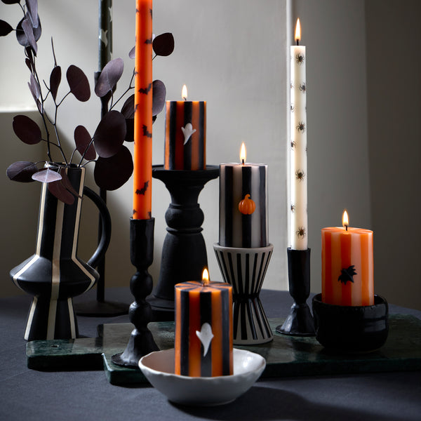 Our tall Halloween candles, in orange, black and white, feature ghosts, bats and spiders, and coloured wicks. Ideal for party decorations. Image2